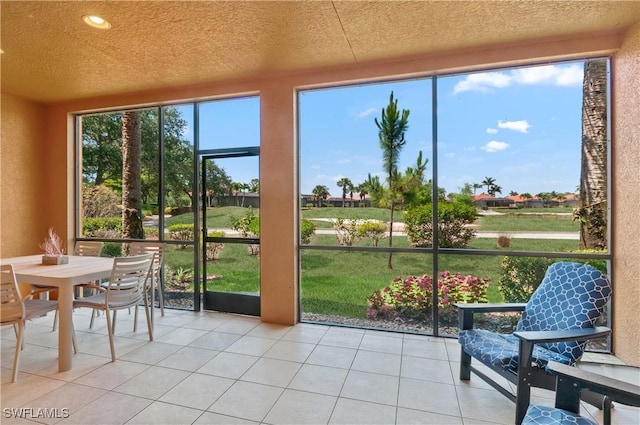 sunroom / solarium featuring outdoor dining area