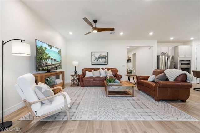 living room featuring recessed lighting, ceiling fan, visible vents, and light wood finished floors