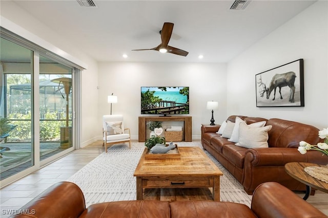 living area with visible vents, baseboards, ceiling fan, recessed lighting, and light wood-style flooring