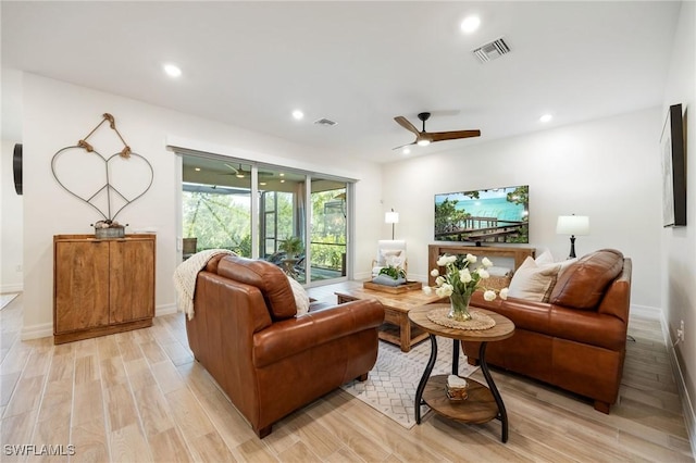 living room with visible vents, a ceiling fan, light wood-style floors, and recessed lighting