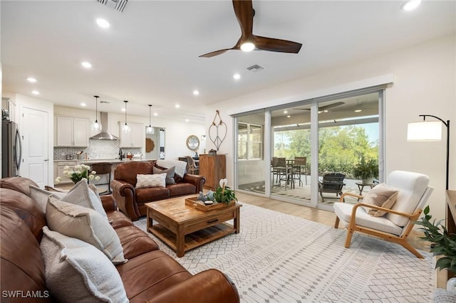 living area featuring visible vents, recessed lighting, light wood-style floors, and ceiling fan