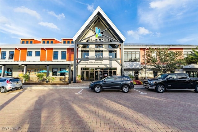 view of building exterior with uncovered parking