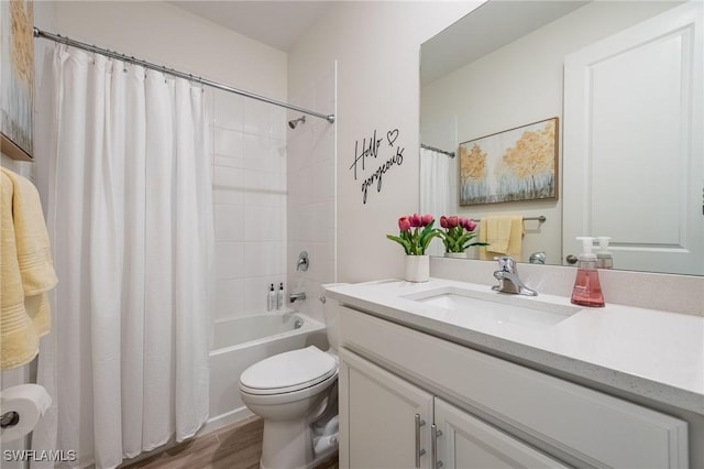 full bath featuring vanity, wood finished floors, toilet, and shower / bath combo with shower curtain