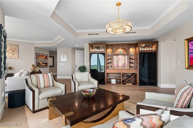4931 Bonita Bay Blvd Unit 601, Bonita Springs, FL 34134 - living room featuring light wood-style floors, a raised ceiling, ornamental molding, and visible vents