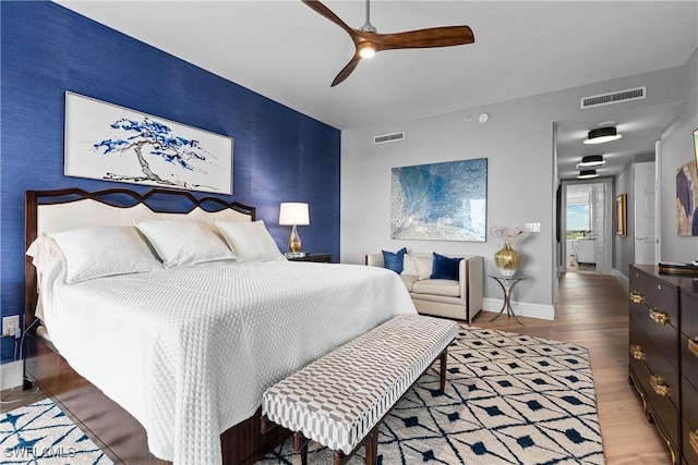 4931 Bonita Bay Blvd Unit 601, Bonita Springs, FL 34134 - bedroom with visible vents, an accent wall, and wood finished floors