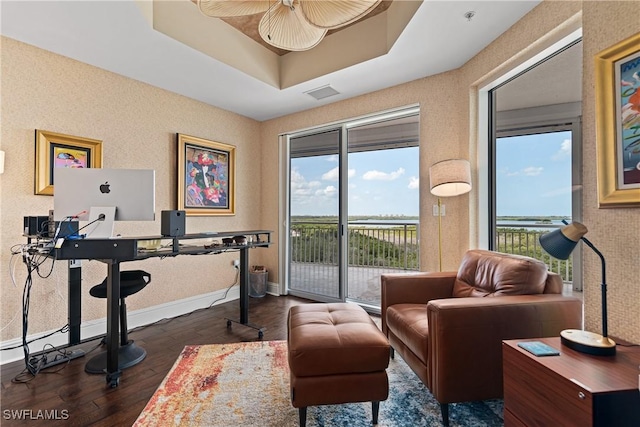 4931 Bonita Bay Blvd Unit 601, Bonita Springs, FL 34134 - living area featuring baseboards, dark wood finished floors, a wealth of natural light, and a raised ceiling