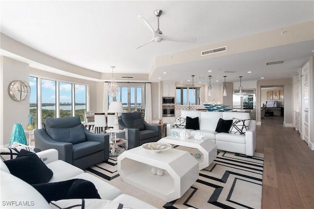 4931 Bonita Bay Blvd Unit 601, Bonita Springs, FL 34134 - living room with baseboards, ceiling fan with notable chandelier, light wood-style flooring, and visible vents