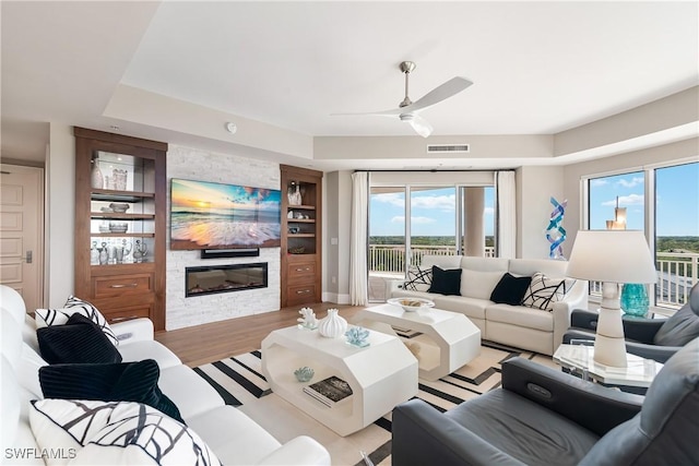 4931 Bonita Bay Blvd Unit 601, Bonita Springs, FL 34134 - living room featuring ceiling fan, a fireplace, light wood-type flooring, and visible vents