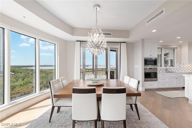 4931 Bonita Bay Blvd Unit 601, Bonita Springs, FL 34134 - dining area with light wood-style floors, a wealth of natural light, a chandelier, and visible vents