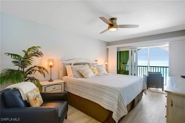 bedroom featuring a water view, access to outside, a ceiling fan, and light wood-type flooring