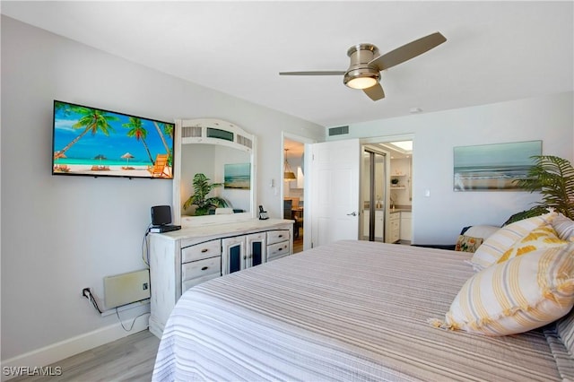 bedroom featuring visible vents, baseboards, ensuite bathroom, ceiling fan, and light wood-type flooring