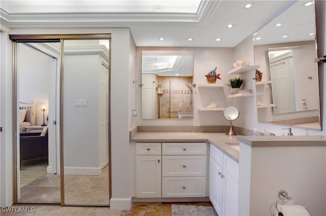 ensuite bathroom featuring vanity, ensuite bathroom, recessed lighting, a raised ceiling, and a tile shower