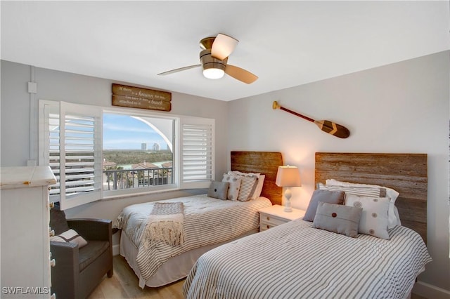bedroom featuring a ceiling fan, baseboards, and wood finished floors