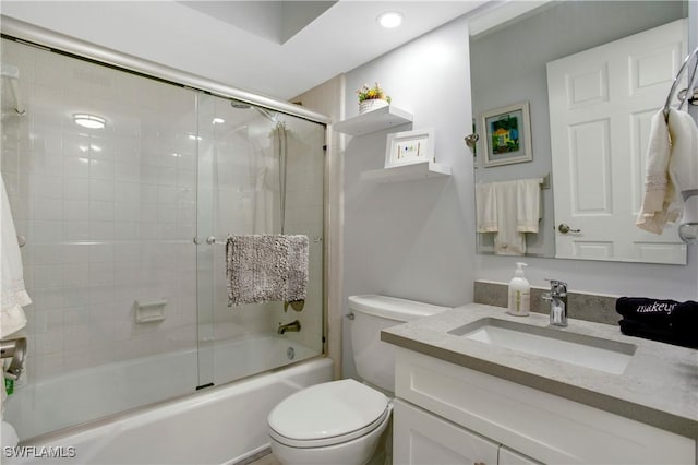 bathroom featuring vanity, recessed lighting, combined bath / shower with glass door, and toilet