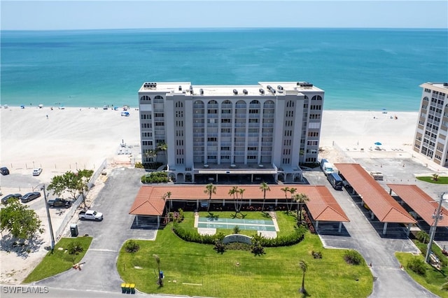 bird's eye view featuring a water view and a view of the beach