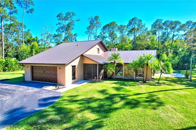 3690 27th Ave SW, Naples, FL 34117 - view of front of house with a standing seam roof, metal roof, driveway, a chimney, and stucco siding