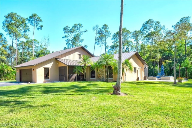 3690 27th Ave SW, Naples, FL 34117 - single story home with a standing seam roof, metal roof, driveway, a front yard, and a garage