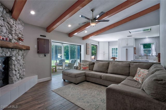 3690 27th Ave SW, Naples, FL 34117 - living area with a ceiling fan, a fireplace, baseboards, beamed ceiling, and wood-type flooring