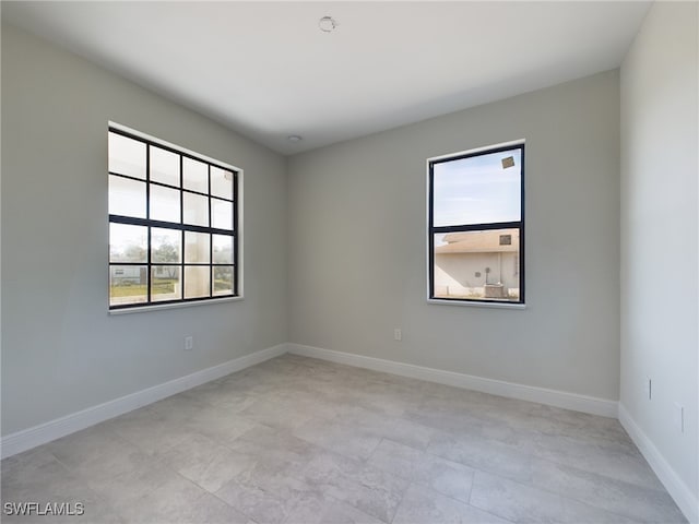2406/2404 Hawalaska St, Lehigh Acres, FL 33973 - empty room featuring healthy amount of natural light and baseboards
