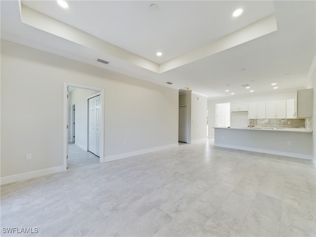 2406/2404 Hawalaska St, Lehigh Acres, FL 33973 - unfurnished living room featuring recessed lighting, a raised ceiling, crown molding, and baseboards