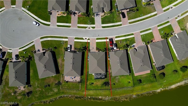 bird's eye view with a water view and a residential view