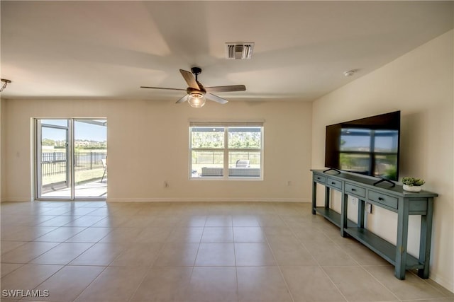 unfurnished living room with a healthy amount of sunlight, light tile patterned floors, ceiling fan, and visible vents