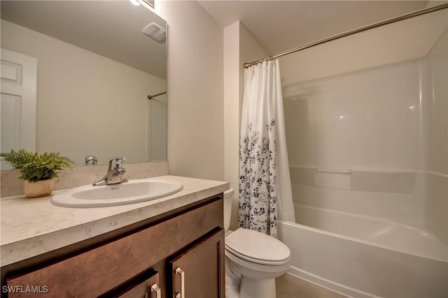 bathroom with vanity, shower / tub combo with curtain, and toilet