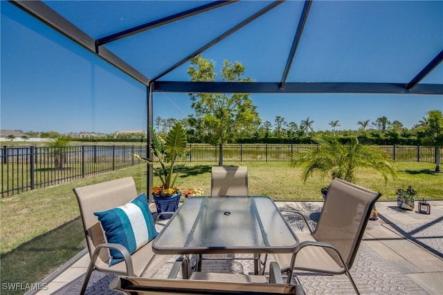 view of patio with a water view, outdoor dining space, and a fenced backyard