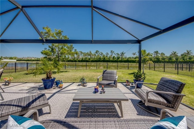 view of patio with a water view, outdoor lounge area, and a fenced backyard