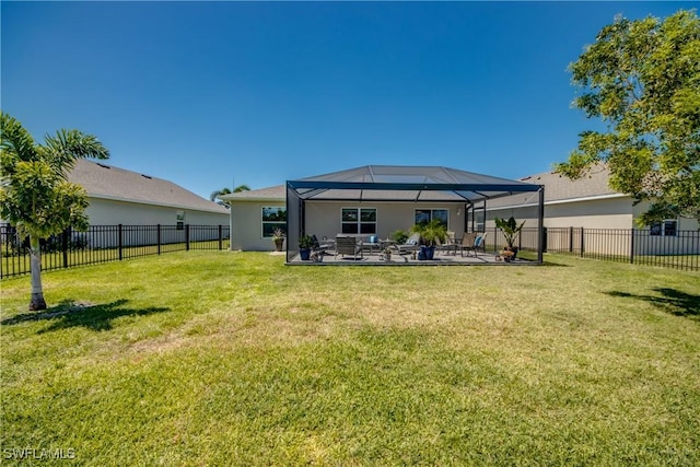 rear view of property featuring a lawn, a fenced backyard, a patio area, and stucco siding