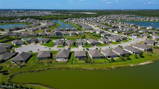 drone / aerial view featuring a residential view and a water view