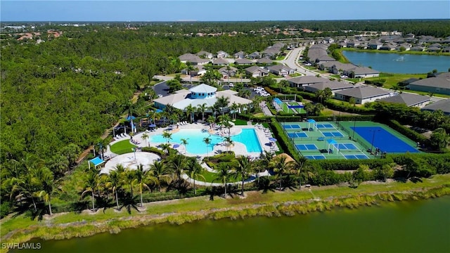 drone / aerial view featuring a water view and a view of trees