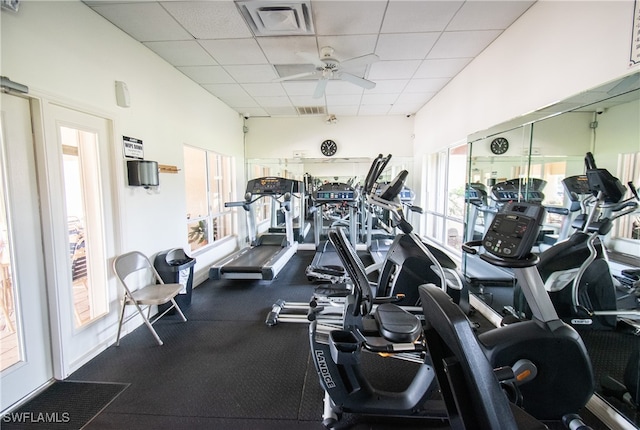 workout area with visible vents, a paneled ceiling, and ceiling fan