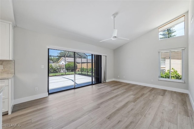 1196 Westlake Blvd, Naples, FL 34103 - unfurnished dining area with ceiling fan, baseboards, high vaulted ceiling, and light wood-type flooring