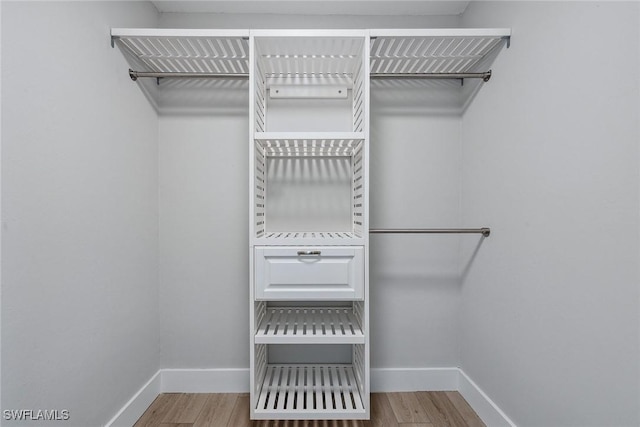 1196 Westlake Blvd, Naples, FL 34103 - walk in closet with wood finished floors
