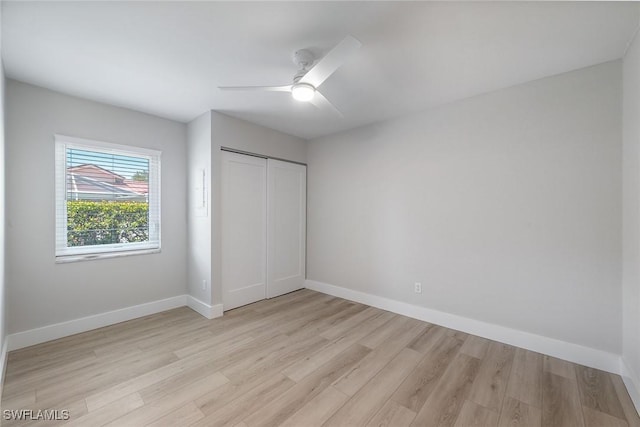1196 Westlake Blvd, Naples, FL 34103 - unfurnished bedroom with baseboards, a ceiling fan, a closet, and light wood-type flooring