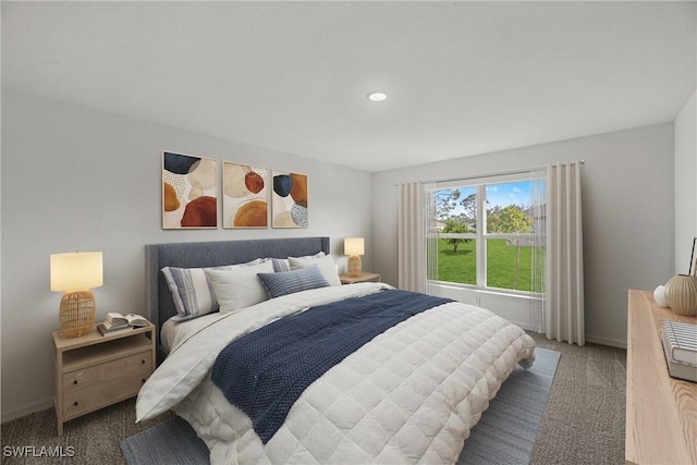 bedroom featuring baseboards and carpet flooring