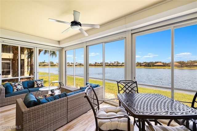 sunroom / solarium with an outdoor hangout area, ceiling fan, wood finished floors, and a water view