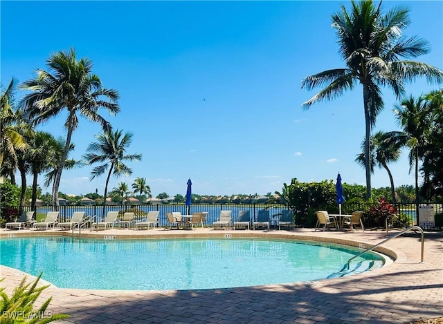 community pool featuring fence and a patio