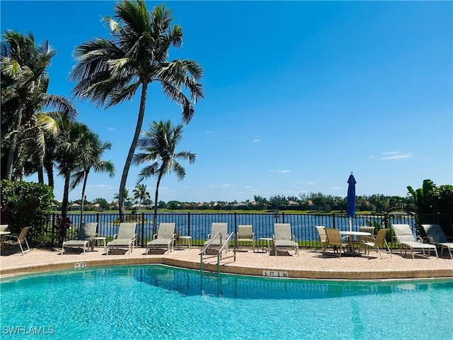 community pool featuring fence and a patio area