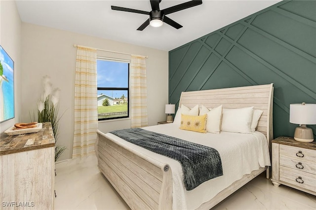 bedroom with a ceiling fan and marble finish floor