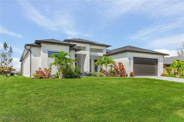 prairie-style home featuring concrete driveway, an attached garage, a front yard, and stucco siding