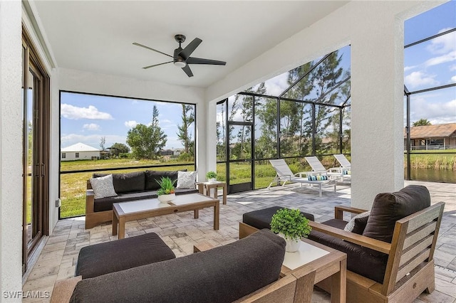 sunroom featuring an outdoor living space and a ceiling fan