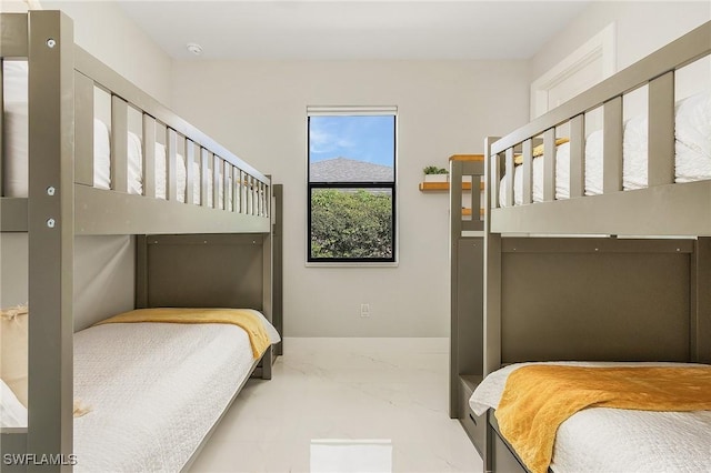 bedroom featuring marble finish floor