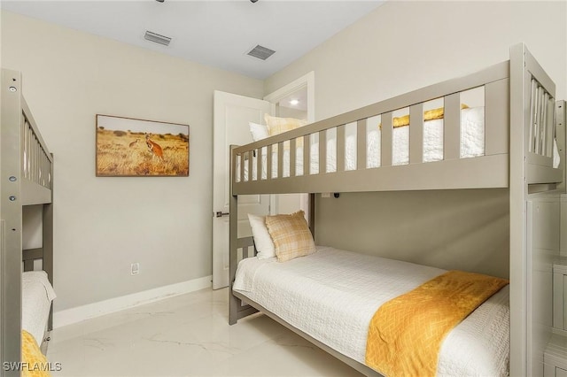 bedroom featuring baseboards, visible vents, and marble finish floor