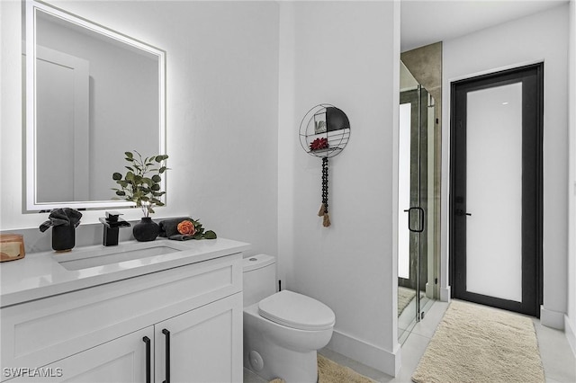 full bath featuring vanity, tile patterned flooring, a stall shower, and toilet