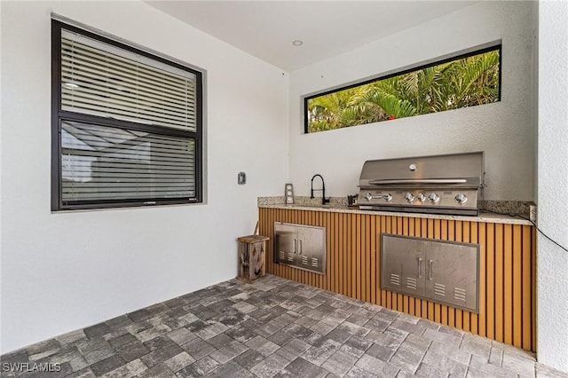 view of patio / terrace featuring a sink, a grill, and area for grilling
