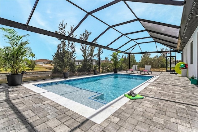 outdoor pool with a lanai and a patio area