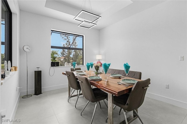 dining room featuring baseboards and a notable chandelier