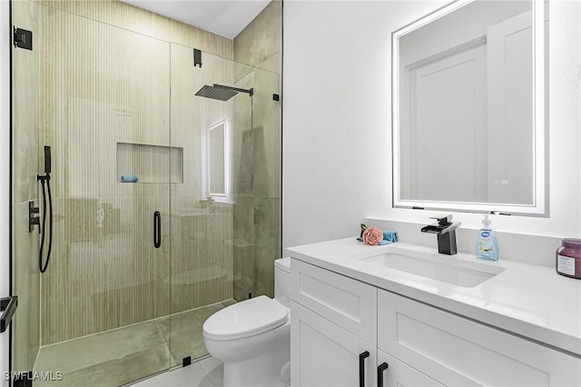 bathroom with vanity, tile patterned floors, toilet, and a shower stall